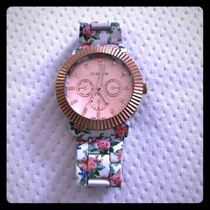Bebe floral watch with rose gold tone face.